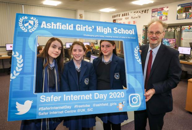 Education Minister Peter Weir with pupils from Ashfield Girls' School holding a sign promoting Safer Internet Day